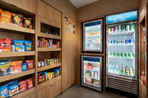 a store with an open refrigerator with food inside at Fairfield by Marriott Inn & Suites Bonita Springs in Bonita Springs