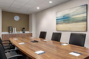 a conference room with a large wooden table and chairs at Fairfield by Marriott Inn & Suites Bonita Springs in Bonita Springs