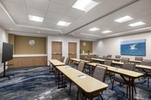 a classroom with tables and chairs and a screen at Fairfield by Marriott Inn & Suites Bonita Springs in Bonita Springs +30 photos