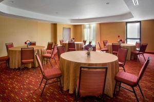 a large room with tables and chairs and a room with tables and chairs at Courtyard by Marriott Paramus in Paramus