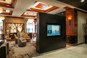 a waiting room with a tv on a wall at Courtyard by Marriott Norfolk Downtown in Norfolk