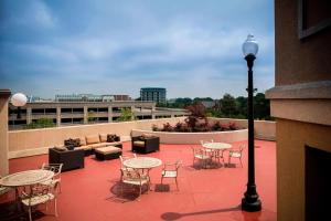a patio with tables and chairs and a street light at Courtyard by Marriott Norfolk Downtown in Norfolk