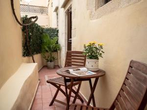 a small table and two chairs on a patio at Venetian Palace Chania in Chania