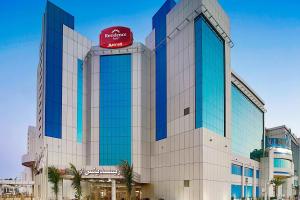 a building with a sign on top of it at Residence Inn by Marriott Jazan in Jazan