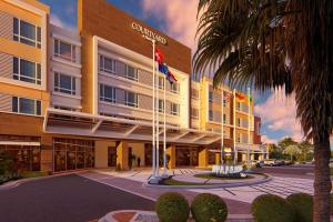 a rendering of a hotel with flags in front of it at Courtyard by Marriott Curacao in Willemstad