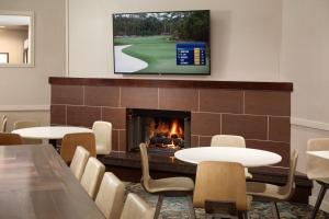 a meeting room with tables and a fireplace at Residence Inn by Marriott Atlanta Buckhead in Atlanta
