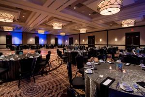 un salón de banquetes con mesas y sillas en una habitación en Wichita Marriott en Wichita