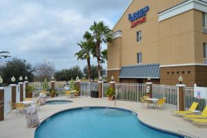 a pool at a hotel with chairs and tables at Fairfield Inn & Suites by Marriott Clermont in Clermont