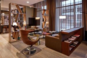 a living room with a desk and a chair at AC Hotel by Marriott Minneapolis Downtown in Minneapolis