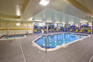 a large swimming pool in a large building at Fairfield Inn & Suites by Marriott Plattsburgh in Plattsburgh