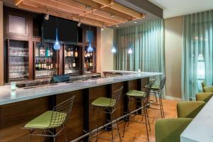 a bar in a hotel room with green bar stools at Courtyard by Marriott Chattanooga Downtown in Chattanooga