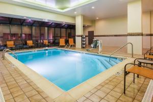 a pool in a hotel room with tables and chairs at Courtyard by Marriott Chattanooga Downtown in Chattanooga