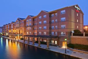 a building next to a river at night at Residence Inn Indianapolis Downtown on the Canal in Indianapolis