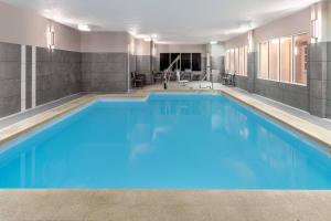 a large pool with blue water in a building at Residence Inn Indianapolis Downtown on the Canal in Indianapolis
