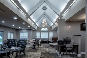 - une salle d'attente avec des chaises, des tables et une fenêtre dans l'établissement Residence Inn by Marriott Little Rock, à Little Rock