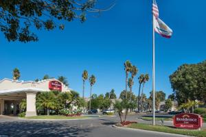 a hotel with a flag in front of a building at Residence Inn by Marriott Oxnard River Ridge in Oxnard
