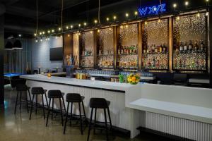 a bar in a restaurant with stools around it at Aloft Dublin-Pleasanton in Dublin