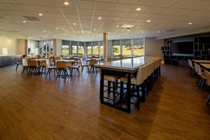 a dining room with tables and chairs and a bar at Residence Inn by Marriott Oxnard River Ridge in Oxnard