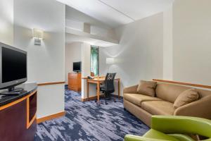 a living room with a couch and a tv at Fairfield Inn & Suites by Marriott Houston Conroe in Conroe