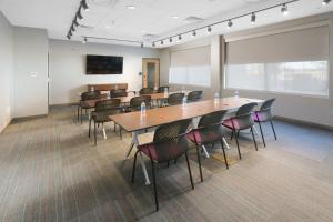 a conference room with tables and chairs and a screen at Aloft Lubbock in Lubbock +21 photos