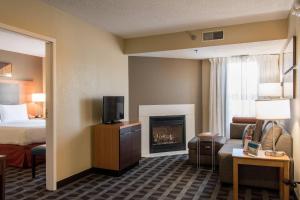 a hotel room with a bed and a fireplace at TownePlace Suites by Marriott Lafayette in Lafayette