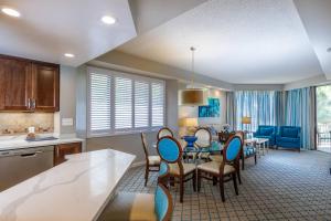 a kitchen and living room with a table and chairs at Marriott's Royal Palms in Orlando