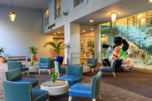 a lobby with a statue of a woman sitting in a chair at Renaissance Wind Creek Curacao Resort in Willemstad