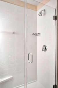 een douche met een glazen deur in de badkamer bij Fairfield Inn Myrtle Beach Broadway at the Beach in Myrtle Beach