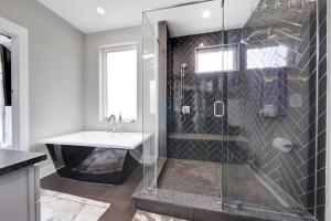 a bathroom with a shower and a sink and a tub at City Views - Walking Distance to Panthers Stadium in Charlotte +40 photos