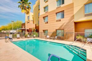 a swimming pool in front of a building at TownePlace Suites by Marriott Phoenix Goodyear in Goodyear