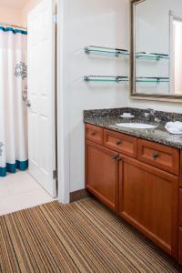 a bathroom with a sink and a mirror at Residence Inn Rockford in Rockford