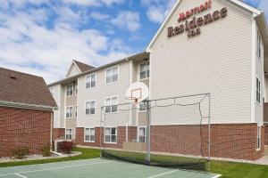 a hotel with a basketball hoop in front of a building at Residence Inn Rockford in Rockford