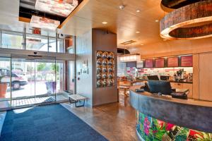 a lobby of a restaurant with a counter at Aloft Phoenix Airport in Phoenix