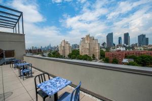 a balcony with tables and chairs and a view of a city at Fairfield Inn & Suites By Marriott New York Brooklyn in Brooklyn