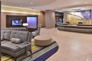 a hotel lobby with a couch and a table at SpringHill Suites by Marriott Raleigh Cary in Cary
