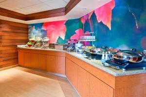 a kitchen with a counter with pots and pans at Fairfield Inn & Suites Jackson Airport in Pearl