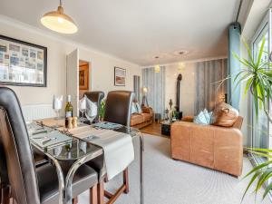 a living room with a dining table and a couch at Albany House in Seaford