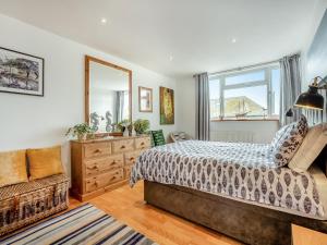 a bedroom with a bed and a mirror and a chair at Albany House in Seaford