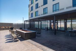 ein Gebäude mit einer Terrasse mit Stühlen und einer Feuerstelle in der Unterkunft Courtyard by Marriott Rapid City in Rapid City