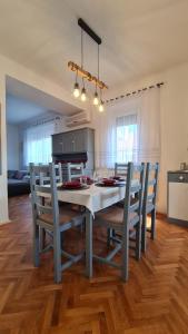 a kitchen with a table and chairs in a room at RI-JÓ apartman in Mohács