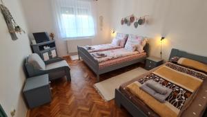 a living room with two beds and a couch at RI-JÓ apartman in Mohács