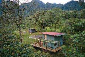 a small house in the middle of a forest at Yátaro Refugio Glamping in La Vega