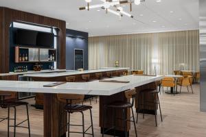 a bar in a restaurant with bar stools at Courtyard by Marriott Houston I-10 West/Memorial in Houston