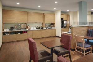 a kitchen with a table and chairs and a counter at TownePlace Suites by Marriott Tampa South in Tampa