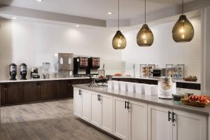 a large kitchen with white cabinets and pendant lights at Residence Inn by Marriott Anaheim Resort Area/Garden Grove in Anaheim