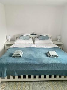 a bedroom with a bed with a blue blanket on it at Apartmán Eden in Bystrzyca