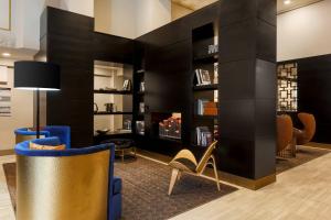 a lobby with black walls and chairs and a fireplace at Courtyard by Marriott San Francisco Union Square in San Francisco