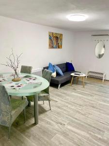 a living room with a table and a couch at Apartmán Eden in Bystrzyca