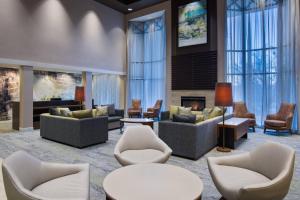 a lobby with couches and chairs and a fireplace at Courtyard by Marriott Springfield Airport in Springfield