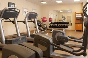 a gym with treadmills and exercise equipment in a room at Greenville Marriott in Greenville